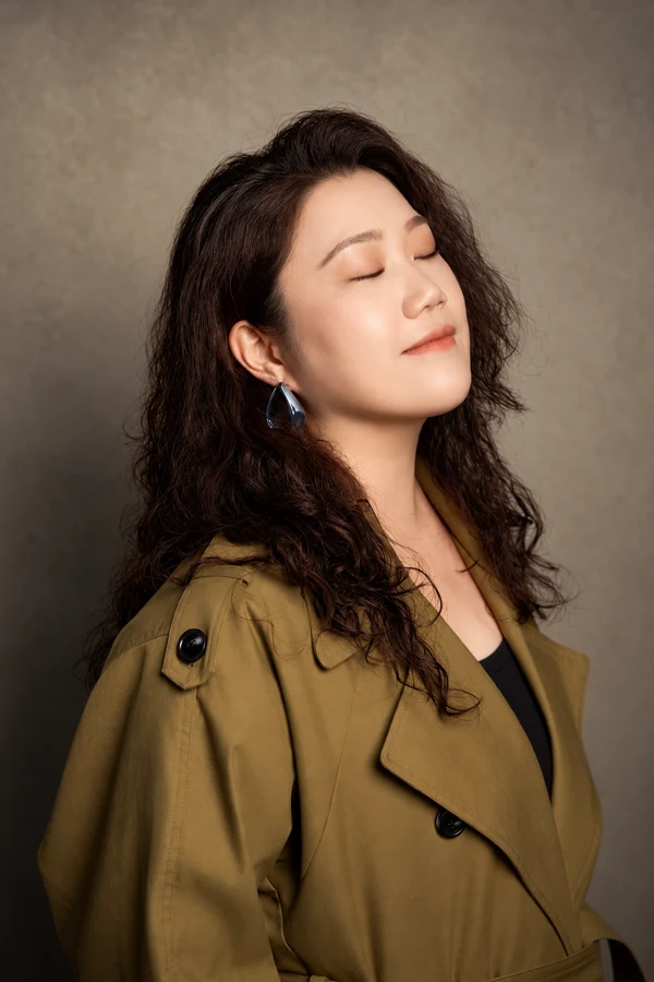 Close-up portrait of Ang Mei Foong with eyes closed